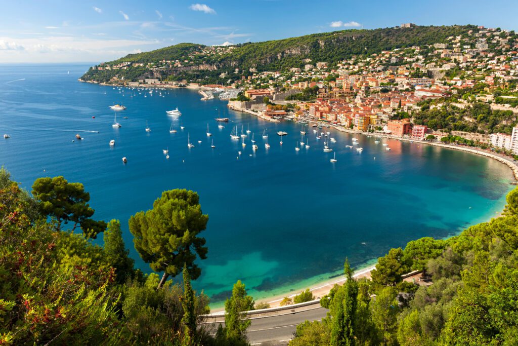 Aerial view of Côte d&#039;Azur Mediterranean coast with medieval coastal town Villefranche-sur-Mer with boats at anchor